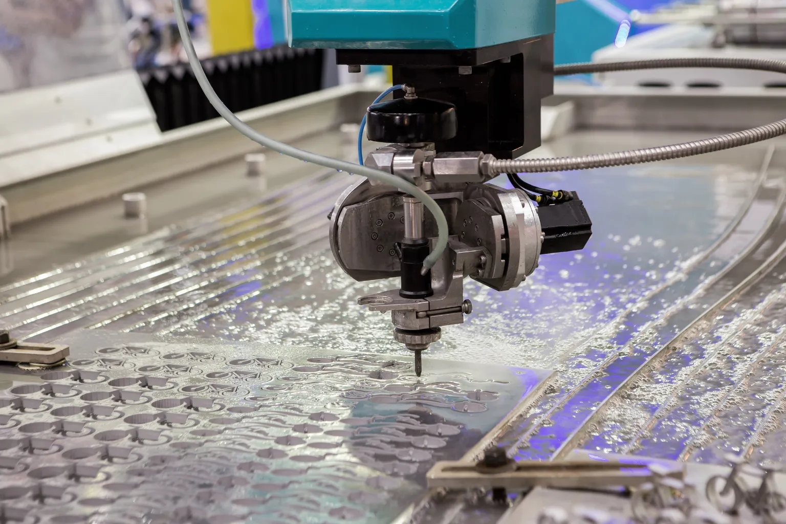 Water jet machine cutting an intricate marble inlay pattern in Dubai.